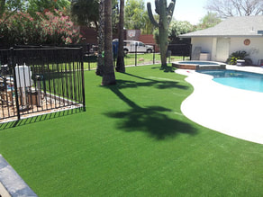 neatly installed artificial grass by the poolside